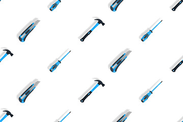 Tools seamless pattern. Tools: hammer, screwdriver and knife on a white background.