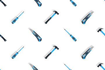 Tools seamless pattern. Tools: hammer, screwdriver and knife on a white background.