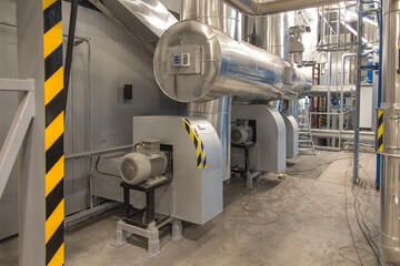 fan with a large electric motor and  ducts and pipes