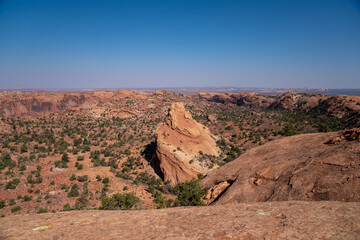 large rock formation coming out of the desert landscape