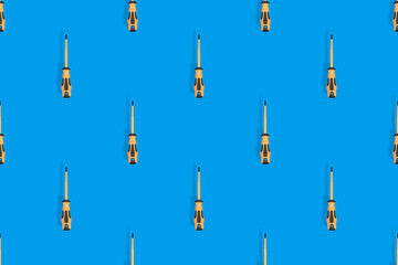 Screwdrivers seamless pattern. Metal screwdrivers with a rubberized handle on a blue background.