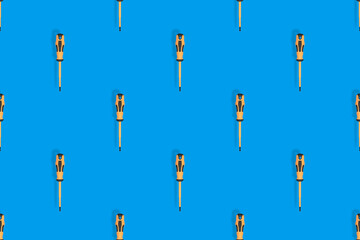 Screwdrivers seamless pattern. Metal screwdrivers with a rubberized handle on a blue background.