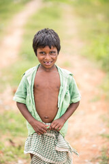 Poor Indian boy in country road side, Tamilnadu, India.