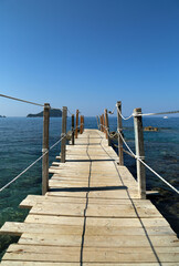 Naklejka premium Landscape with wooden bridge in the sea