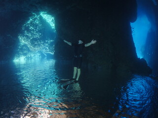 scuba divers underwater enjoying the rocks topography clean water scenery exploring the reef ocean scenery