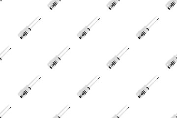 Screwdrivers seamless pattern. Metal screwdrivers with a rubberized handle on a white background.