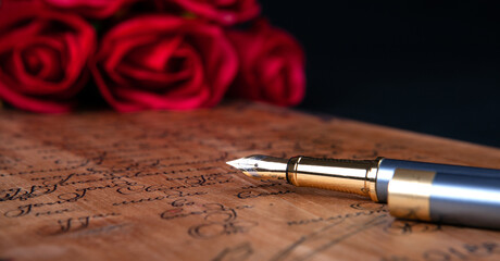 fountain pen on letter with text and red roses