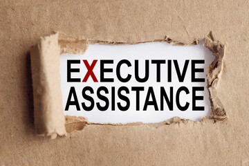 executive assistance, text on white paper on torn paper background