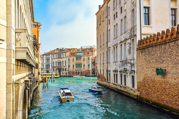 view of the canal in Venice. Boats sail in opposite directions