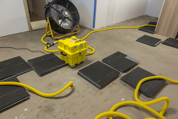 Drying a concrete floor under a fabric covering. After pouring, initial drying, and then drilling and blowing hot air
