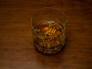 Glass of Natural Whisky on Wooden Table