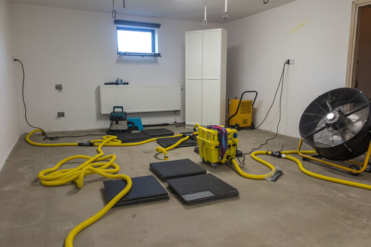 Drying a concrete floor under a fabric covering. After pouring, initial drying, and then drilling and blowing hot air