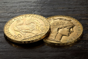 French 20 Francs gold coins on rustic wooden background