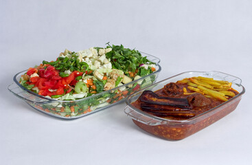 Iranian traditional food named Gheymeh and a dish of vegetables and salad