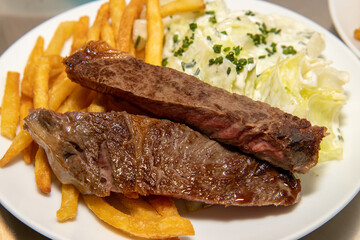 A plate of delicious stake and chips on a white plate