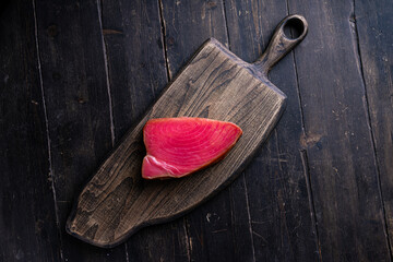 Cold Smoked Tuna Fillet . Seafood on a wooden chopping board. Top view. 