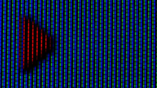 Working pixels in the screen color TV, with a video playback close up. Red running arrow on a blue green pixel background. Macro.