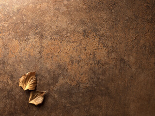 background of worn leather, present dry leaves resting on the surface