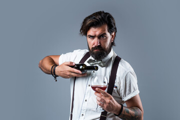 brutal bearded male with stylish look drink wine, barkeeper