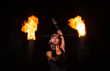 Burning desire. Sensual woman twirl flaming baton in darkness. Fire performance. Art show. Baton twirling. Holiday celebration. Night party. Desire and passion