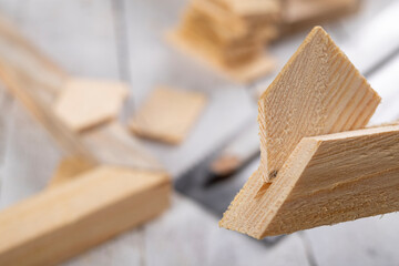Angular connection of two pieces of wood. Making a wooden frame for a painting. Workplace carpentry workshop.