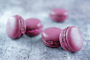 Berries macarons with cream filling and fresh strawberries and raspberries