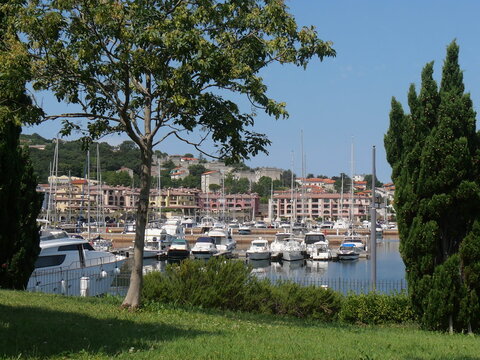 San Rocco : panorama of the modern marina with luxurious boats and modern buildings surmounted by manicured green lawns