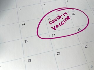 covid-19 coronavirus vaccine shot appointment on calendar,  background with copy space 