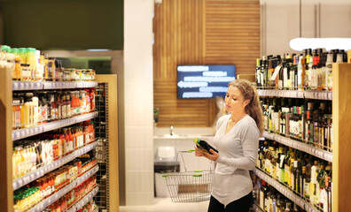 Woman choosing a dairy products at supermarket	
