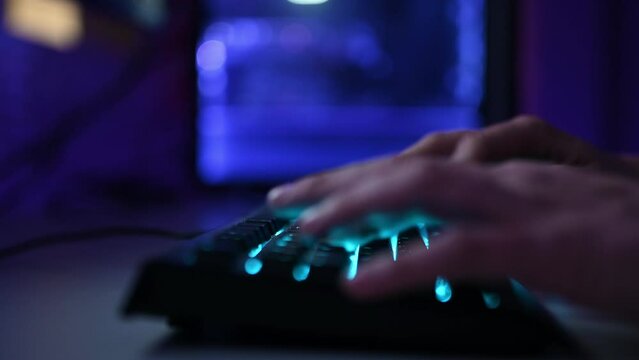 gamer boy hands typing on keyboard close up