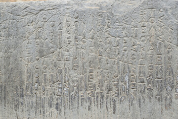 View of the main monuments of Greece. Ruins of ancient Delphi. Oracle of Delphi. Mount Parnassus. Stone wall with ancient Greek inscriptions
