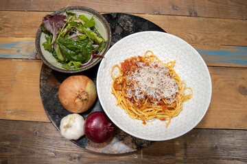A plate of delicious tuna pasta spaghetti bolognese topped with grated cheese
