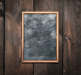 rectangular brown wooden frame on a background of very old boards