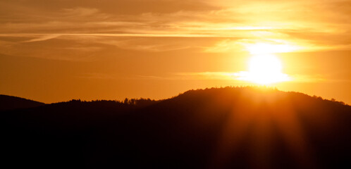 Zachód słońca nad górami. Pomarańczowe niebo sylwetka gór. © Andrzej
