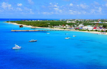Beautiful blue ocean, boats and white sandy beaches along the bay near Grand Turk, Turks & Caicos