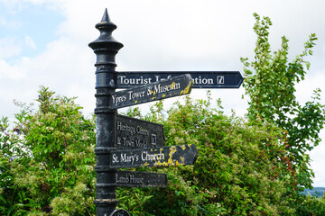 Rye, England - A tourist information sign with arrows pointing in the directions of tourist sites such as Ypres Tower and Museum and St Mary's Church, in Rye.  Image has copy space.
