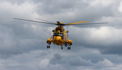 Search and rescue helicopter against stormy skies