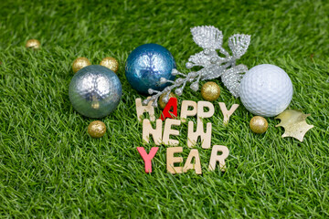 Happy New Year with golf ball on green grass