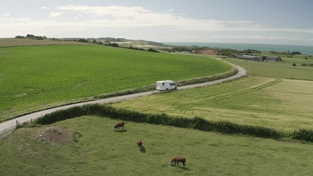 Aerial view of motorhome on country road.