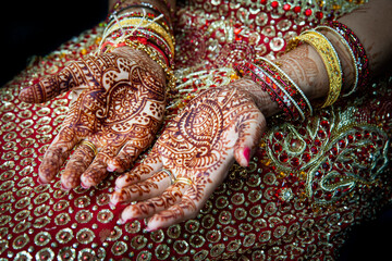 Close up of Mehndi tattoos on the hands of a Hindu or Sikh bride