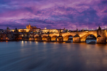 Fototapeta na wymiar panorama prague castle and charles bridge and st. vita church lights from street lights are reflected on the surface of the vltava river in the center of prague at night in the czech republic