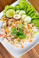 Shrimp fried rice on a wooden table from a top view
