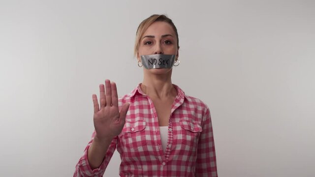 The social messaging woman taped her mouth, the tape on her mouth says no sex.The young woman who wanted to give a social message taped her mouth, the tape on her mouth says no sex. 