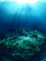 Fototapeta na wymiar sun ray and sun beam scenery underwater waves on surface of water slow ocean scenery