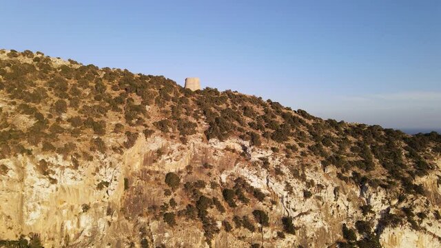 Aerial View of Torre des Savinar Tower near Ibiza, es Vedra and Vedranell islands. Drone footage in the Balearic islands.