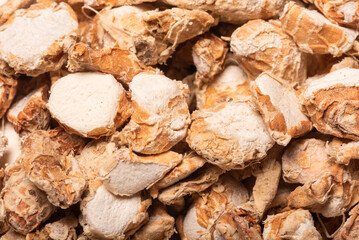 Sand ginger, latin name Kaempferia galanga dried roots heap extreme close-up view