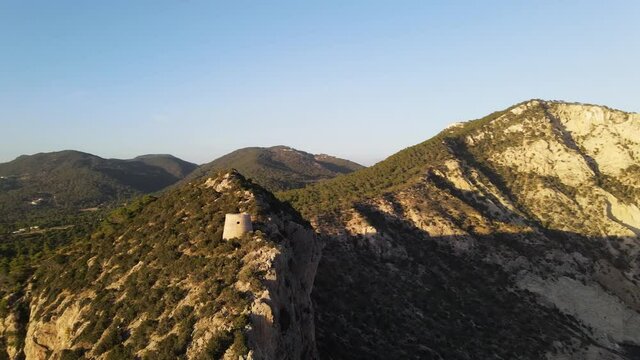 Aerial View of Torre des Savinar Tower near Ibiza, es Vedra and Vedranell islands. Drone footage in the Balearic islands.