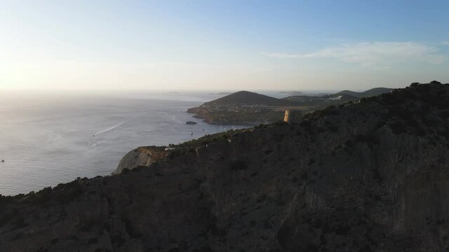 Aerial View of Torre des Savinar Tower near Ibiza, es Vedra and Vedranell islands. Drone footage in the Balearic islands.