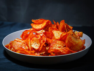 spicy cassava chips isolated on black background