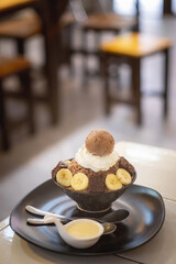 Brownie and banana bingsu serve with white cream on top